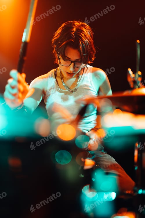 Preview: Drummer playing drums during live performance on stage