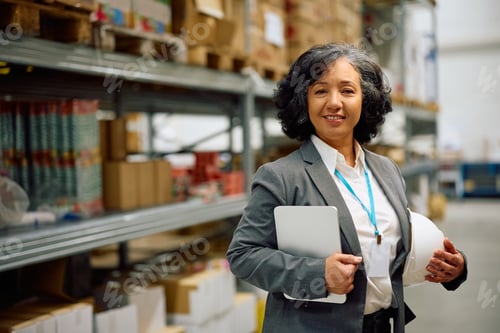 Preview: Portrait of female warehouse inspector at work looking at camera.