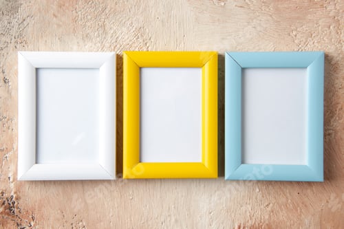 Preview: Side view of colorful three photo frames hung on mix color wall with free space