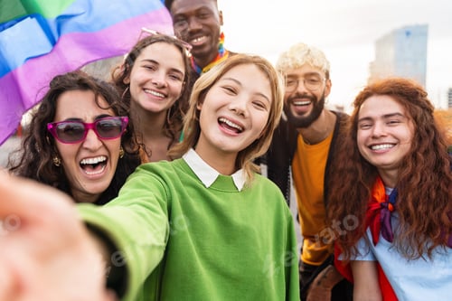 Preview: Asian woman taking selfie photo of diverse friends having fun with LGBT gay rainbow flags