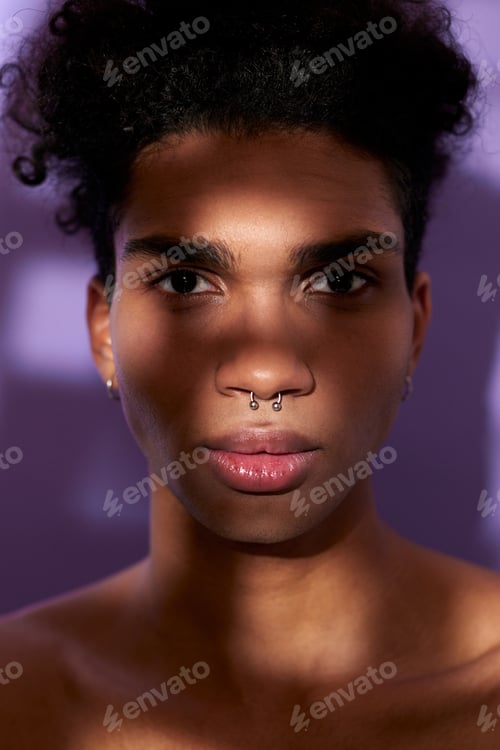 Preview: Close up verticale portrait of young man face in shadow and texture light. Handsome latin