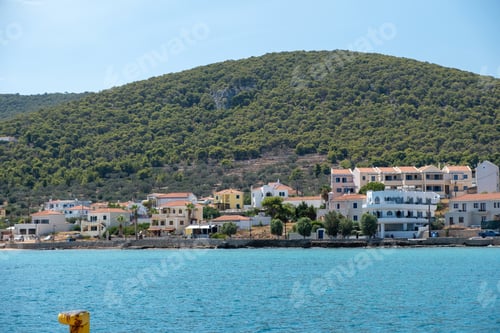 Preview: Greece, Megalochori, Milos, Miloi port, Agistri island. Seaside building, tree, sea, sky, sunny day.
