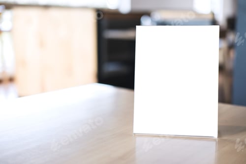 Preview: Mock up blank menu frame on table in coffee shop stand for your text of display your product