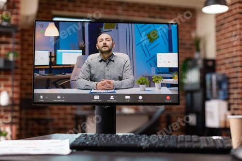 Preview: Close up of video conference with man on computer