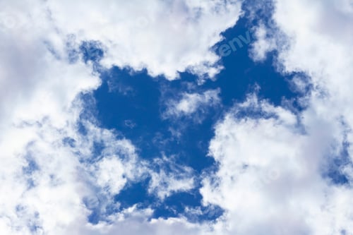 Preview: Cumulus flat or cumulus humilis clouds in blue sky, view from below.Abstract natural background
