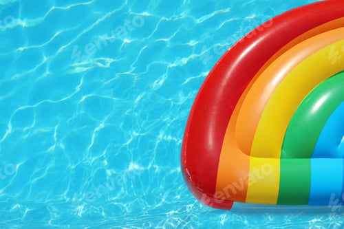 Preview: Inflatable mattress floating in swimming pool on sunny day, top view. Space for text