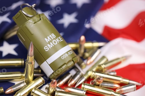 Preview: M18 smoke grenade and many yellow bullets and cartridges on United States flag