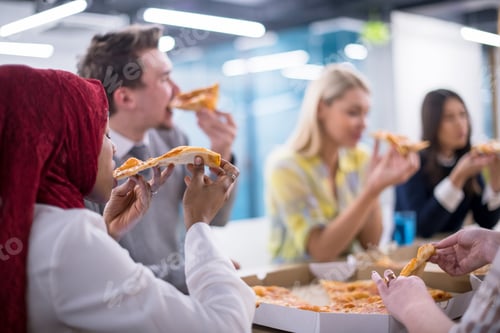 Preview: multiethnic business team eating pizza