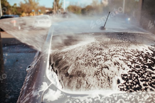 Preview: a man washes a car with a pistol at a self-service car wash