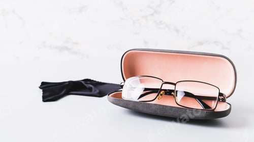 Preview: Eyeglasses in Case With Cleaning Cloth on Table
