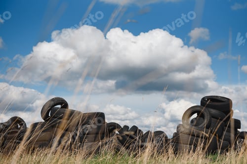 Preview: Old used tires stacked with high piles. Environmental pollution concept