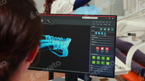 Preview: Stomatologist nurse looking at digital dental fingerprint on computer