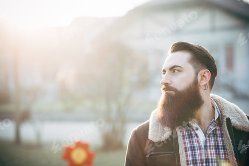 Preview: Young bearded man, building in background