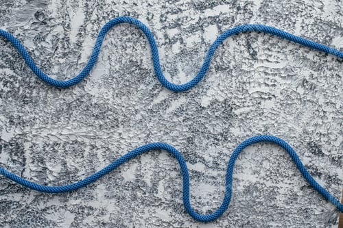Preview: Isolated photo of climbing knots. Cables lying on the white and grey colored surface