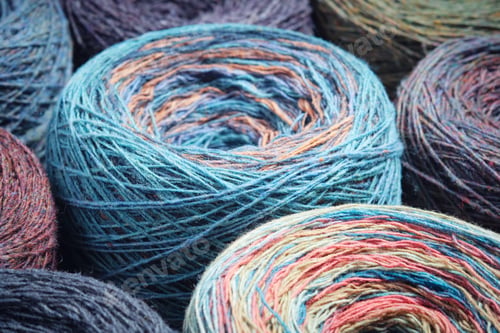 Preview: Round skeins of organic multi-coloured lambswool yarn.