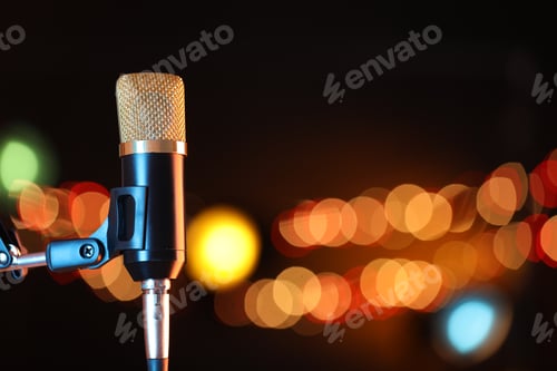 Preview: Microphone on stand against dark background with blurred lights, space for text. Bokeh effect