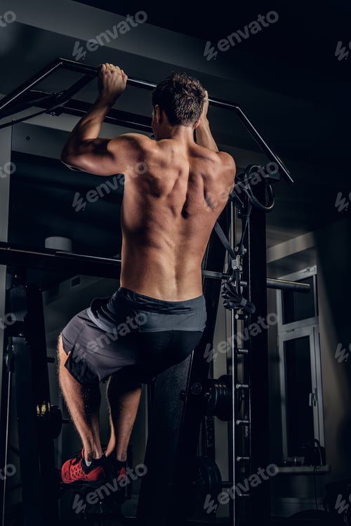 Preview: A man doing pull ups on the horizontal bar.