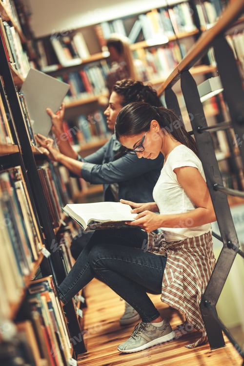 Preview: Group of female students study in the college library.