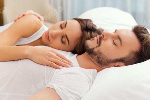 Preview: Feeling calm and comfortable. Beautiful loving couple sleeping together in bed
