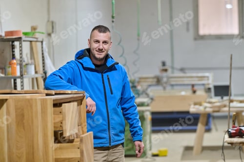 Preview: Close Up of Worker Carefully Cutting and Planing Wooden Pieces for Furniture in Wood Industry