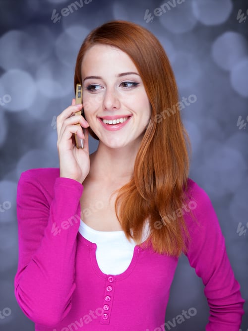 Preview: Redhead girl using mobile phone.