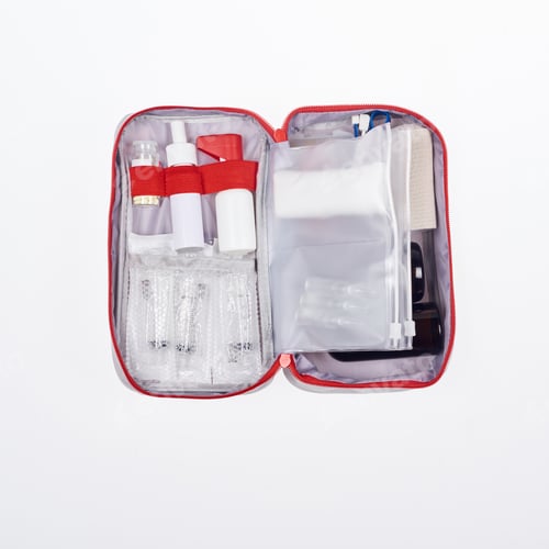 Preview: top view of automotive first aid kit with different medicines isolated on white