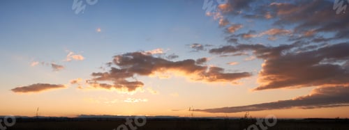 Preview: Sun sets low on horizon, casting golden glow across landscape.