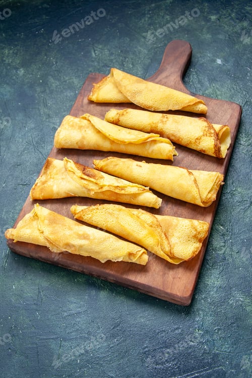 Preview: front view delicious rolled pancakes on dark background pie meat pastry hotcake sweet meal color