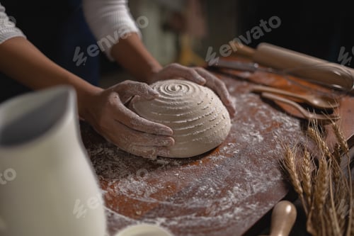 Preview: Close up Hand of baker chef is making with flour loaf of dough
