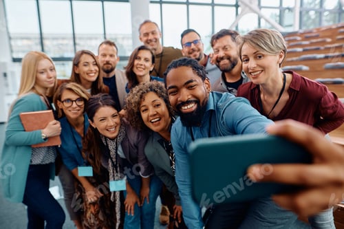 Preview: Multiracial group of happy business seminar attendees taking selfie in conference hall.