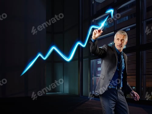 Preview: Businessman painting the stock market development with light