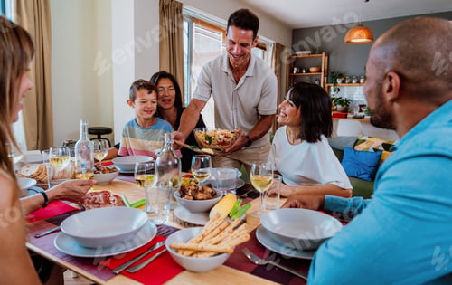 Preview: Family and friends reunion at home. Diverse family gathering enjoying dinner at home