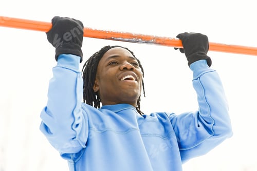 Preview: African american man doing exercise on winter day