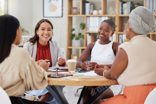 Preview: Diverse group of smiling business women having a brainstorm meeting in office. Happy confident prof