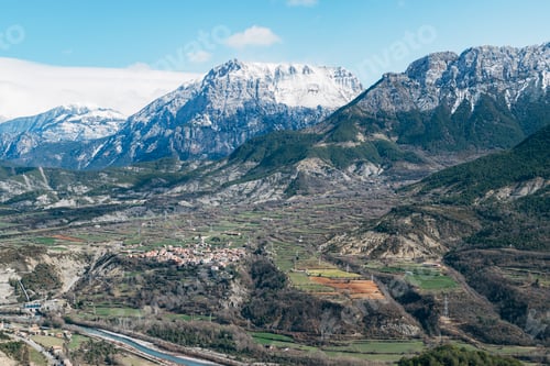 Preview: Photograph of set of snowy mountains in a valley.