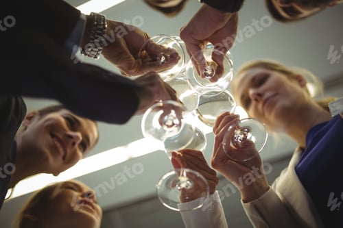 Preview: Businesspeople toasting glasses of champagne