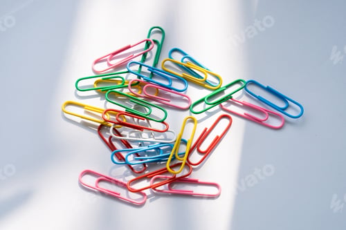 Preview: Coloured paper clips close-up on a white background