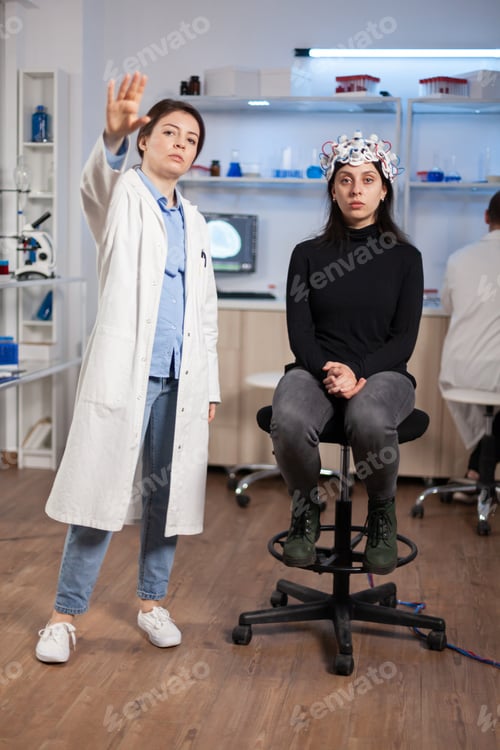 Preview: Brain scientis and patient in laboratory looking at virtual display