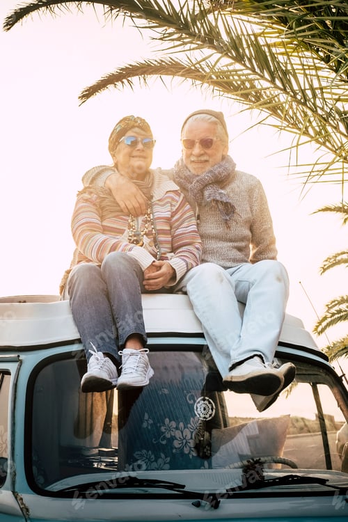 Preview: Couple of old senior traveler sit down together on the roof of the van enjoy the sunset time togeth