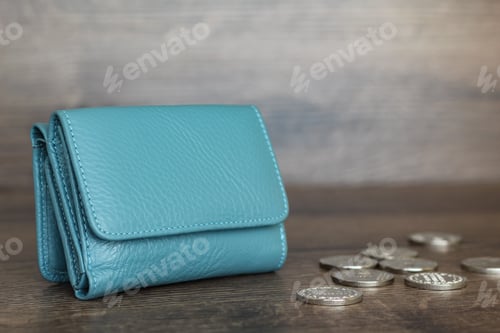 Preview: Coins and wallet on a wooden background. Stack of coins.
