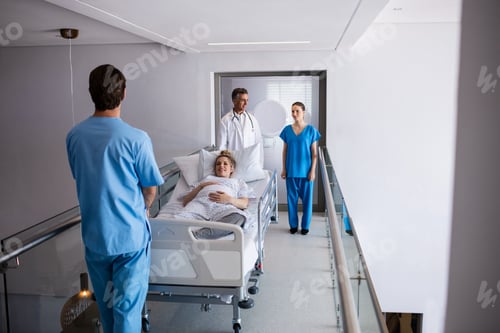 Preview: Team of doctors interacting with each other while examining pregnant woman