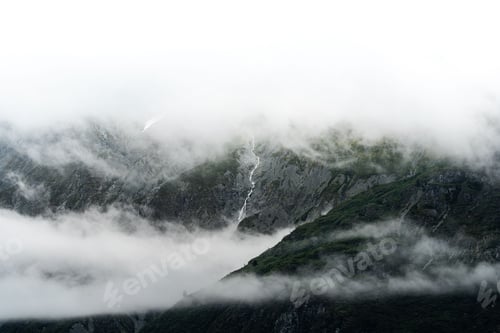 Preview: Beautiful view of a landscape with mountains and clouds in Alaska