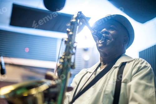 Preview: Male musician in recording studio, playing saxophone