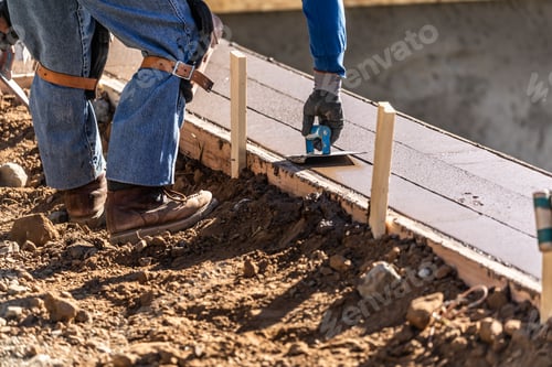 Preview: Construction Worker Using Hand Groover On Wet Cement Forming Coping Around New Pool
