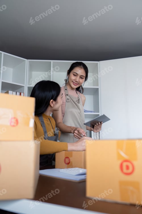Preview: Two Friends Collaboration on Online Sales Business with Cardboard Boxes and Digital Tablet in