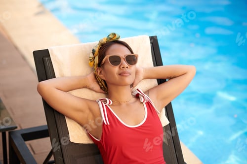 Preview: Relaxed Woman Sunbathing by Pool
