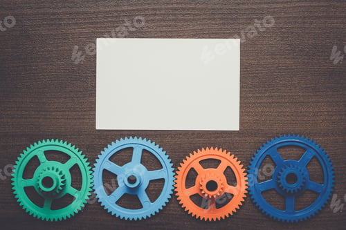 Preview: colorful gears on the brown wooden background