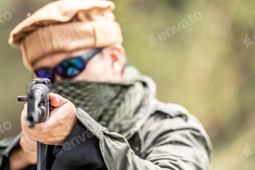 Preview: Militant Fighter Aiming Assault Rifle in Jungle Terrain