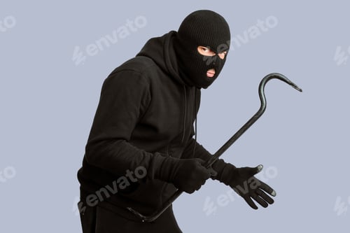 Preview: Thief wearing black mask and hoodie looking angrily at camera