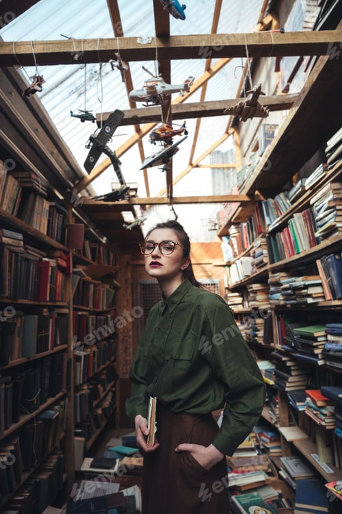 Preview: Portrait of woman with book looking camera